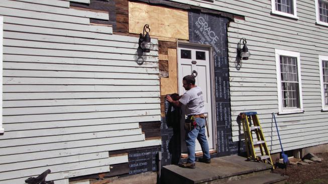 I loosened the clapboard siding around the door, removing any that had cracked or rotted, and patching in pieces of new sheathing where the old had to be replaced.
