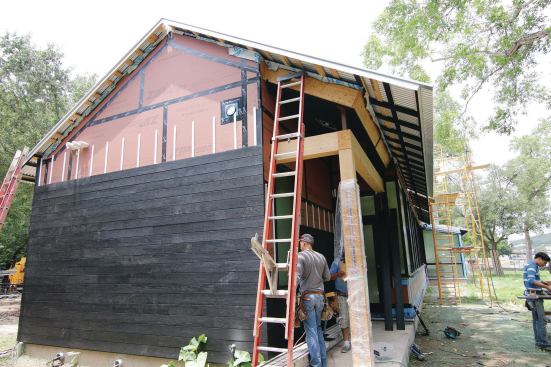 When a separate rainscreen will be installed, the housewrap doesn't need to be textured. Here, taped Huber Zip Wall sheathing was used with a rainscreen.