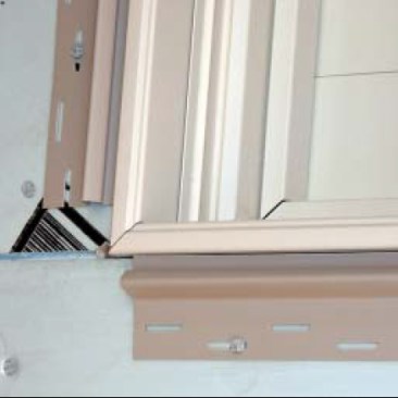 In combination with Andersen flanged vinyl windows, says Caulkins, no special furring or attaching method is required: Window flanges extend far enough from the wall to cover all foam edges. Crews flash the window openings with self-adhering membrane, fasten the window directly to OSB-sheathed wall, and then apply a two-piece window surround from CertainTeed.