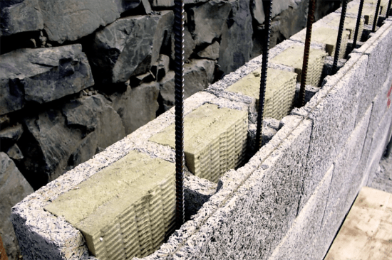 ICFs from Nexcem are made with cement-bonded wood waste. The ones shown here are filled with Rockwool insulation inserts.
