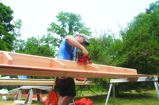 The ledger board was ripped on a 29-degree angle and hand-planed the board to match the descending rafter angles.