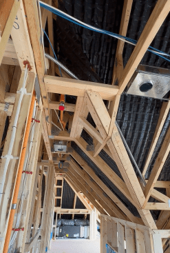 In each  bay, the battens are covered with sturdy plastic baffles, shown here before the spray foam roof insulation was applied in each bay.