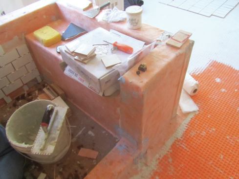 To prevent water damage, all surfaces within the shower enclosure must be completely covered.
