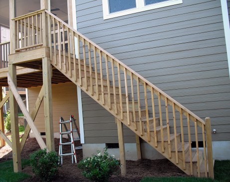Stair guard posts should be located so that the span between posts (as measured horizontally) is no more than six feet. This is a photo of a new deck that has passed inspection.