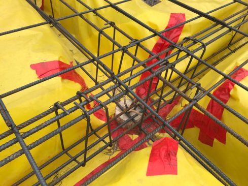 Even with all this rebar the tough Stego Vapor Barrier stands up to the abuse. That’s a steel pile in the center of the beam. See my video for more on the steel piles we used.