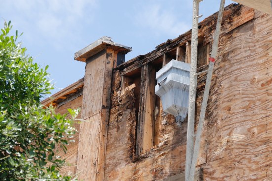 Extensive damage in this area was due mainly to a leak at the parapet wall cap. This is a flat roof and the parapet is the short wall at the top (which hides the flat roof).