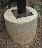 Figure 3. Piers rising above grade keep steel columns out of the dirt. Making them a larger diameter provides a larger target for locating the column, and helps to spread the load on the footing. Attaching columns with 1/2-inch bolts and wedge anchors adds stability and resists wind lift.