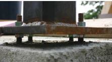 The baseplates rest on setting nuts, which are used to plumb the column and adjust it to finished elevation.
