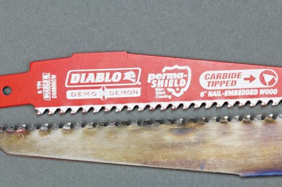 Both of these blades are Demo Demons; the lower one has made 126 cuts through nail-embedded wood. Although the carbide tips have been dulled, they remain intact and can still cut –  though at a slower rate than when sharp.
