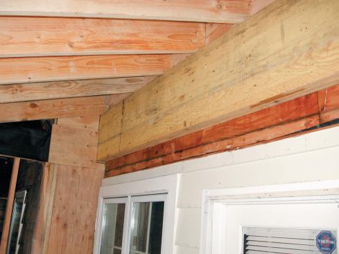 Before opening up the house’s rear wall, the crew bolted a pair of 1-3/4-inch by 18-inch LVLs through the exterior sheathing and into the second-story floor framing to support the shed roof of the addition and the second-story framing of the main house.