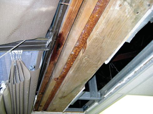 Next I called for removal of the drywall ceiling to further narrow the possible entry location. From what I could see inside, I suspected that the laps in the flashing had failed, if they ever worked in the first place. We had no choice but to rent a&nbsp; bucket truck and — very carefully, considering the glass below — start deconstruction.