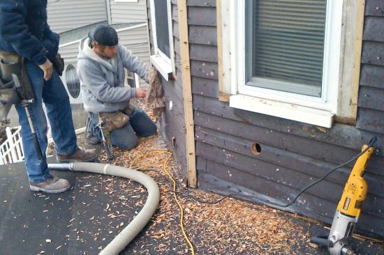Because the original balloon-framed walls had never been insulated, dense-pack cellulose was easily blown into the empty stud cavities from the exterior.