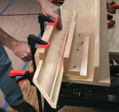For accurate coping, the author secures the crown with a jig so that he can look directly down the cut line while keeping the saw blade tilted a little past plumb.