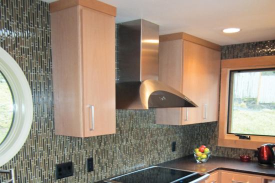 The high-end range hood mounts to the wall on a concealed bracket, with a telescoping two-part rectangular chase above it. It’s made for an 8-foot ceiling but we only had 7 feet 8 inches, the only way to make it work was to shorten the rectangular chase — a task we farmed out to a local sheet-metal shop.