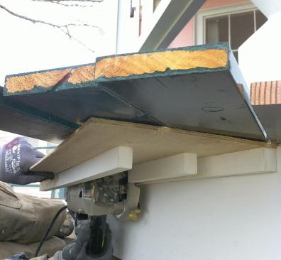 One person manned the saw while another crew member removed the decking offcuts.