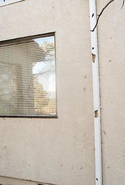 Storm damage — from hail, wind, lightning, and other weather events — is the second largest category of insurance restoration work (after water damage). The side of this house was pocked and dented by hail.