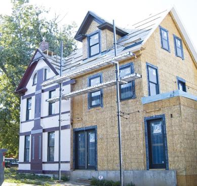 Blending this three-story addition with the existing home involved matching the cornice returns of the original structure.