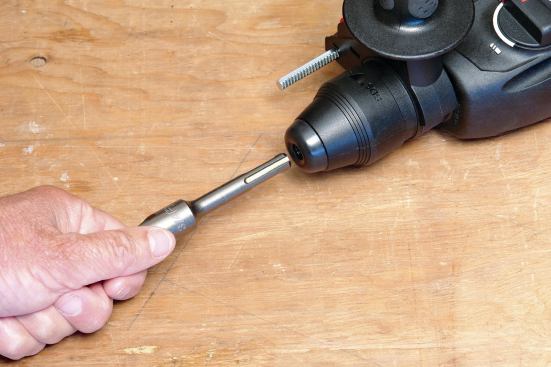 The bits that fit these tools have identical slotted shanks; to install one, you align the shank so it enters the chuck and push until you hear a click.