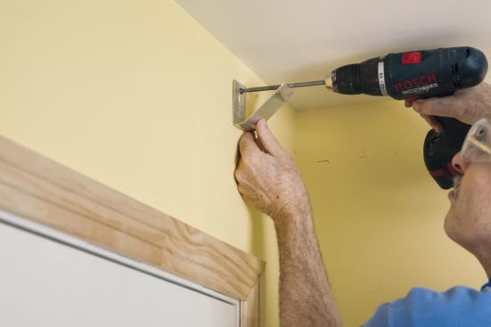 Install the hook with a loosely driven screw placed so that it won’t interfere with the crown.