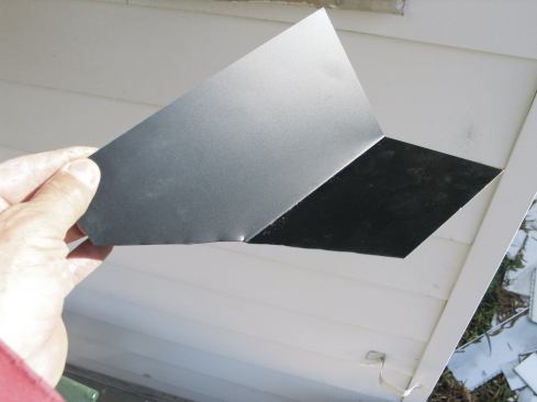 Next, I cut a piece of step flashing at an angle