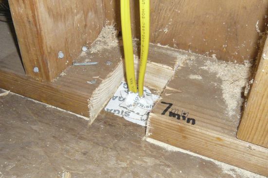 We used a Sawzall to expose the holes in the subfloor, then sealed the pipe or wiring with tape.