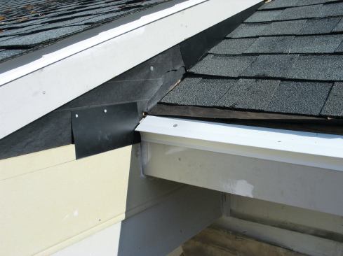 Then I installed a rectangular piece of aluminum flashing so that it covered the top edge of the siding and extended down to the pencil line.