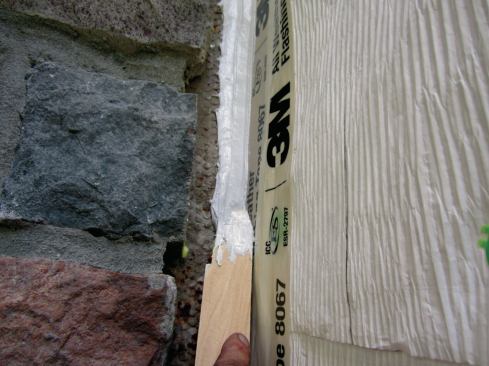 Ordinarily we would wrap the inside corner with housewrap (being careful to avoid having a joint), but in this repair we took extra care to ensure that no water got behind the housewrap by flashing the corner with tape and using a healthy portion of sealant, tooled over the tape, to create as good a barrier seal as we possibly could.