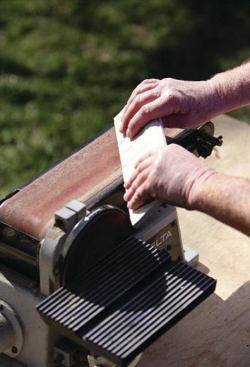 A BELT SANDER FOR SHAPING EDGES

One of the biggest time-savers in my tool kit is a bench-top belt sander fitted with a coarse-grit belt (29). I use this tool to finish any visible cut edges that won’t be concealed with overhanging trim. Smoothing tile edges can be done by hand with a rubbing stone, but that takes time and energy. A belt sander can do the work in a matter of seconds.
