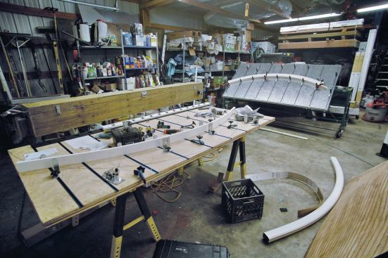For custom bending, the author built forming tables equipped with adjustable clamps.