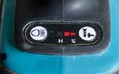 An electronic control on the Makita's base allows users to choose different impact settings — hard for heavy tasks like driving lags, soft for driving finish screws, and medium for in between. The button on the left controls the LED light.