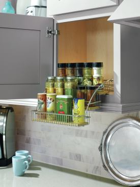 Space-saving storage. Organizational products like Diamond Cabinets’ pull-down spice rack