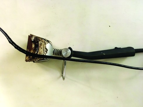 The new, compact  Speedheater Cobra  is designed for smaller surfaces. The  heating element does not get as hot as a torch or heat gun,  but caution still applies. Electrical tape on the power cord and  melted portions of the metal shroud clearly show the need to  be careful when setting the tool aside during use.