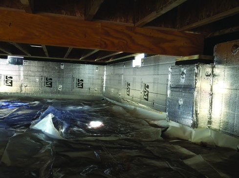 The walls of the crawlspace shown above have been insulated and waterproofed, and a temporary ground cover is in place.  Temporary foundation wall vents are left open until the house is drywalled, power is turned on, and the HVAC system is  operational so that the space can be conditioned.