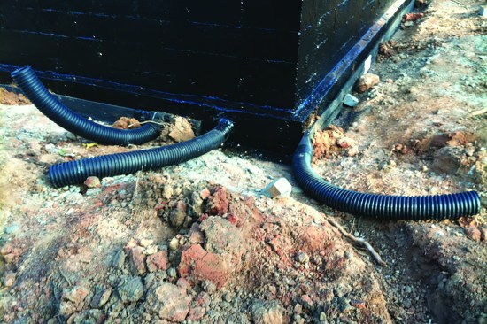 Exterior waterproofing and drainage help defend the space against ground moisture.