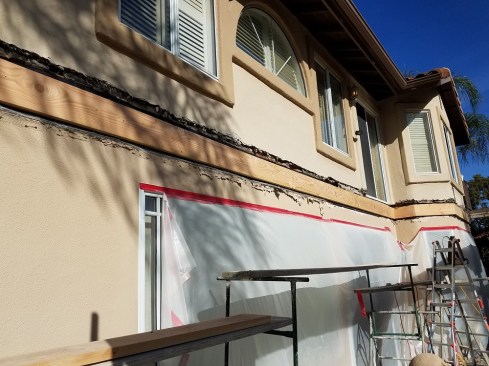 The author cut through the stucco to create a channel so that the new ledger could be bolted to the framing.