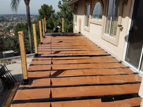 To keep the area under the deck dry and useable, the new deck features a deck drainage system.