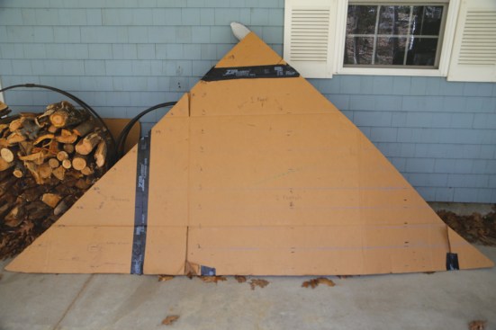 A cardboard template of the uniformly sized dormer gables simplified cutting the panels to fit.