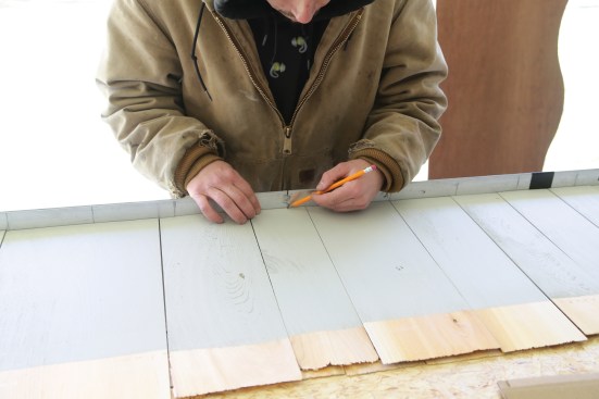 Working from both the centerline marked on the straightedge ...