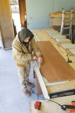 ... a worker draws the pattern on the shingles.