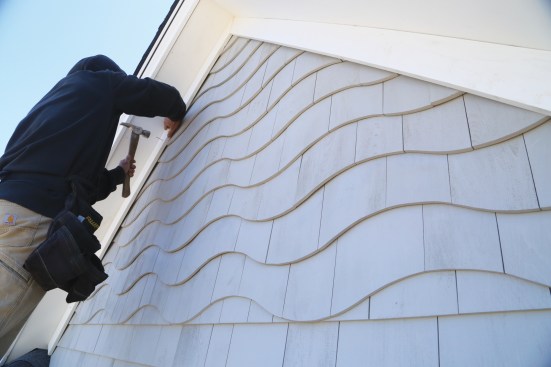 The rake frieze trim covers the diagonal drywall shims that hold the strips together.