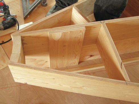 Plywood cleats tie the back of each riser to the back of the box below it.