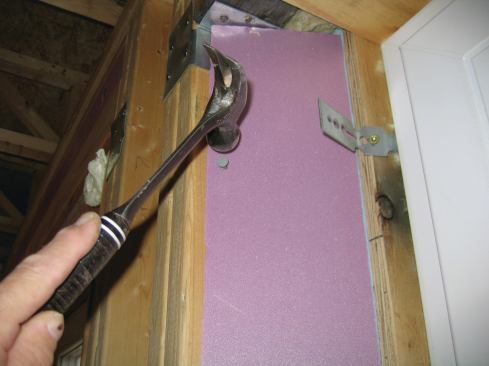 On each flared side, I tacked angle-ripped 3/4-inch rigid insulation in place, keeping it back from the plywood bucks.