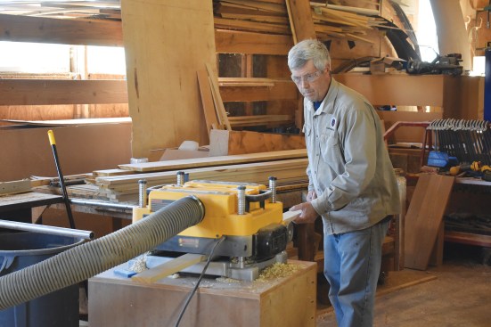 Solid maple is planed flat before glue-up.