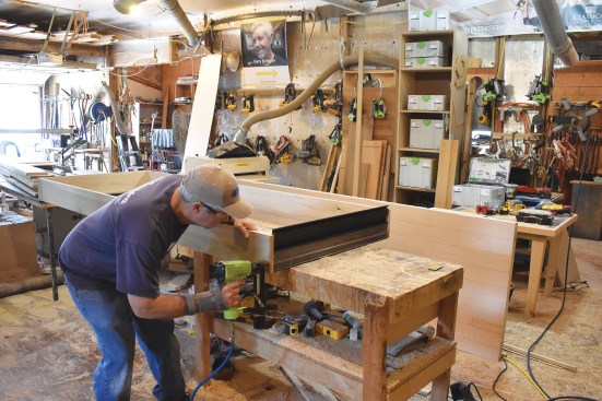 The author attaches a store-bought threshold to the jamb.